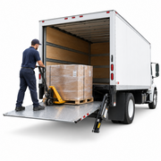 Lift Gate Service with a worker using a pallet jack to unload a large box from a truck's lift gate.